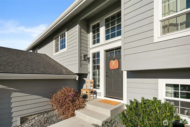 a front view of a house with plants