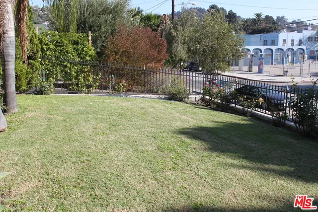 a view of a house with a yard and sitting area