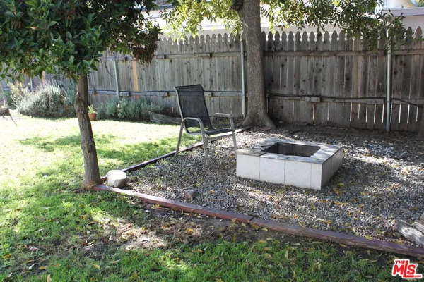 a view of a backyard with a small cabin and a chair