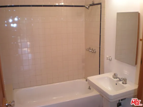 a bathroom with a shower and a sink