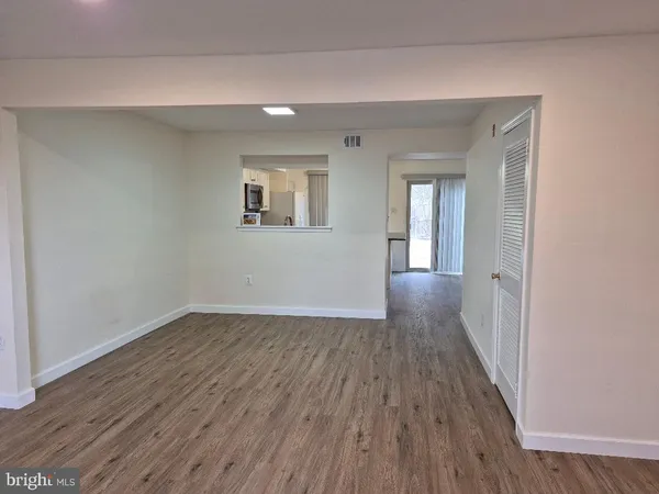 a view of a room with wooden floor and window