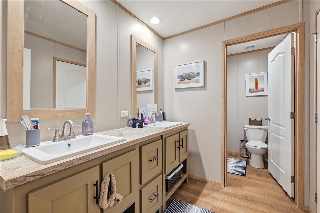 193 Firefly Drive Springtown, TX 76082 - Photo 26 of 32 Double vanity with light wood-finish framed mirrors and brushed nickel fixtures