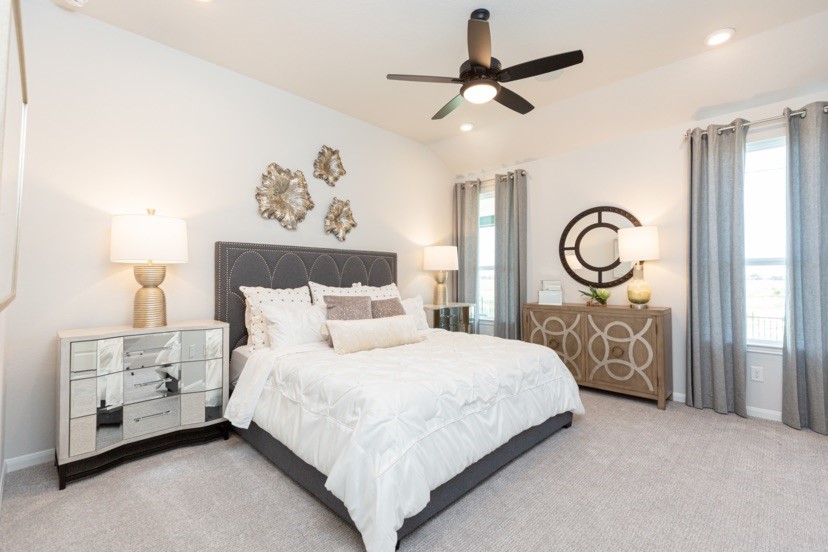 2039 Frst Strm Way Conroe, TX 77304 - Photo 5 of 8 a bedroom with a bed a mirror and a lamp on dresser