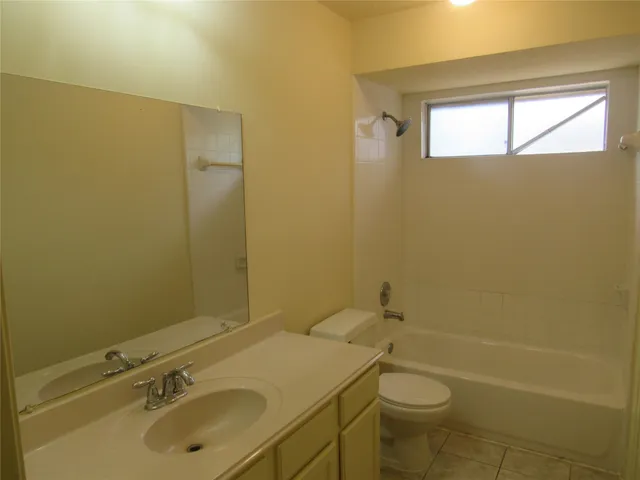 a bathroom with a sink a toilet and tub