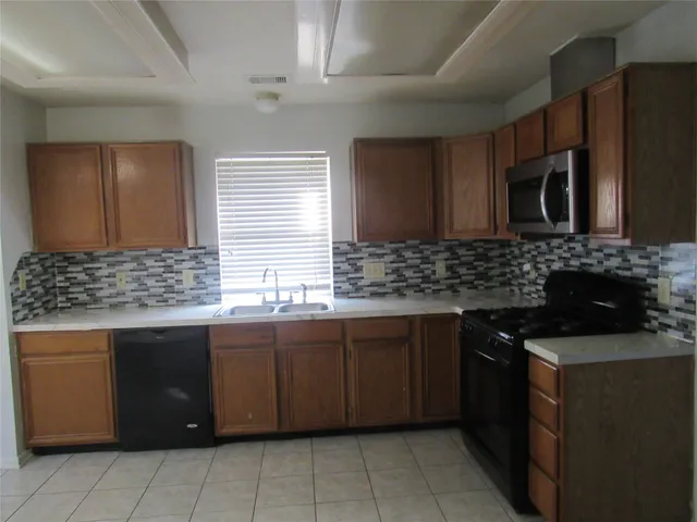 a kitchen that has a sink and a stove