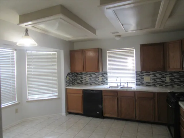 a kitchen with a sink and a window