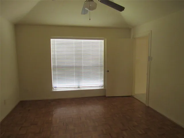 a view of a livingroom with an empty space and a window