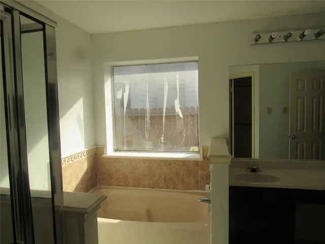 a bathroom with a bathtub and a sink