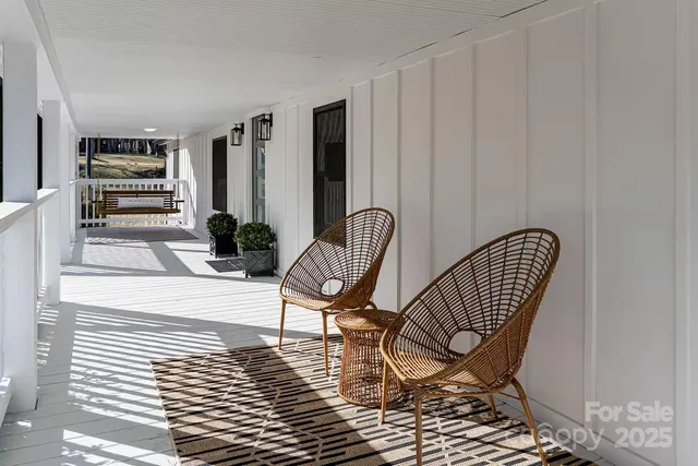a view of a hallway with wooden chairs