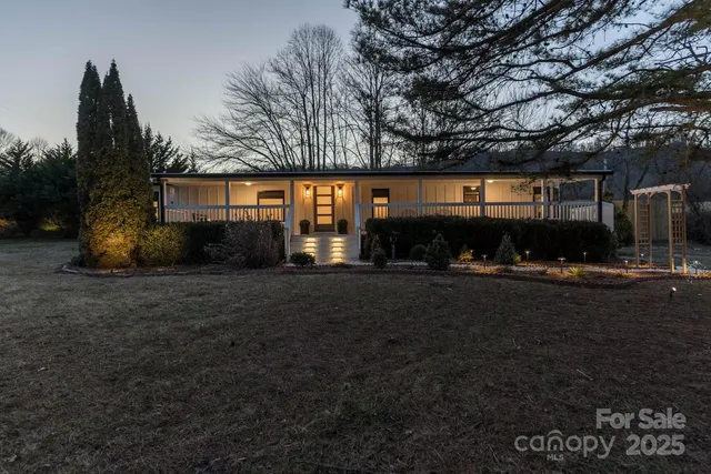 a view of backyard with outdoor seating and green space
