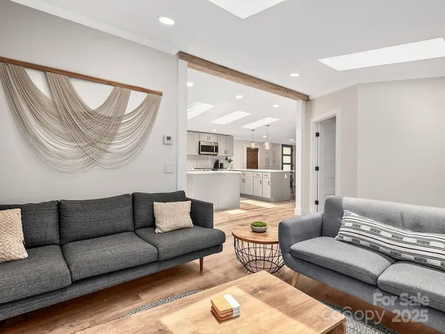 a living room with furniture and a glass door
