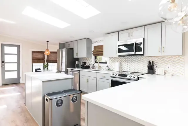 a kitchen with a sink a stove and cabinets