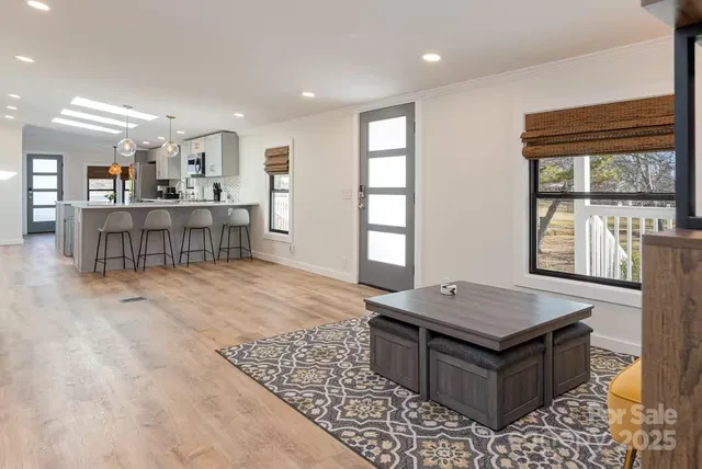 a living room with a table and a window