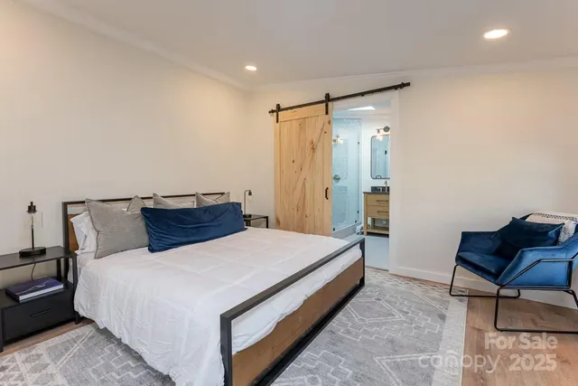 a bed room with a bed and chair