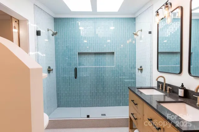 a bathroom with a granite countertop bathtub shower sink and mirror
