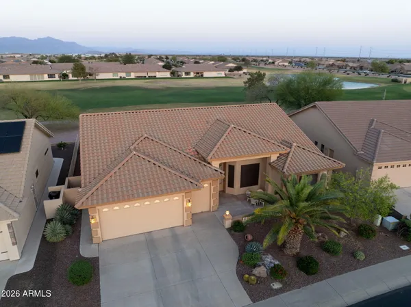 an aerial view of a house with a yard and lake view