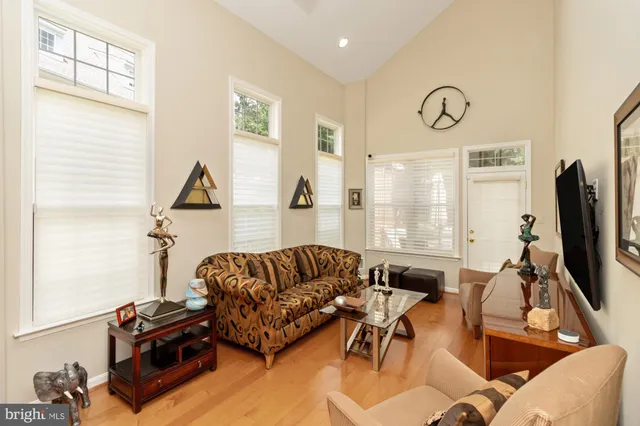 a living room with furniture flat screen tv and a large window