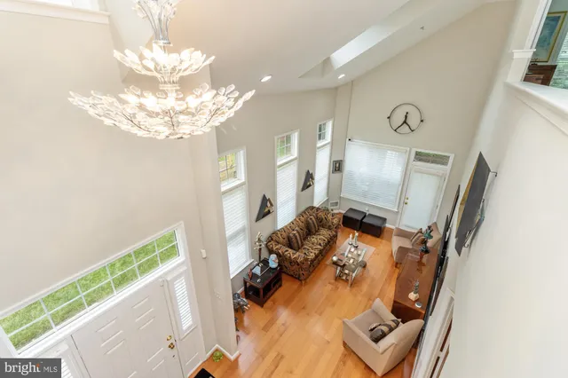 a view of a living room with furniture and a chandelier