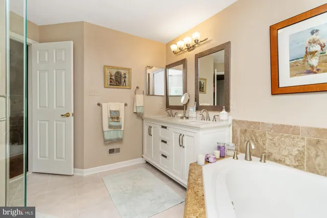 a bathroom with a double vanity sink mirror and