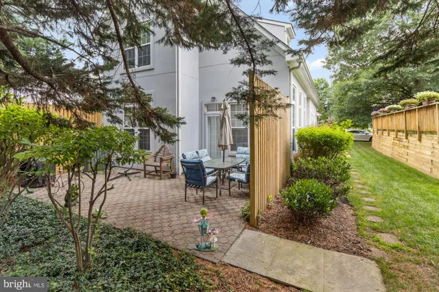 a view of a backyard with sitting area and garden