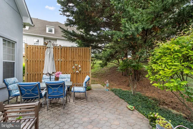 a view of a chairs and tables in the back yard of the house