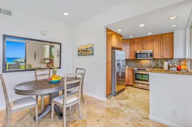 a kitchen with refrigerator cabinets dining table and chairs