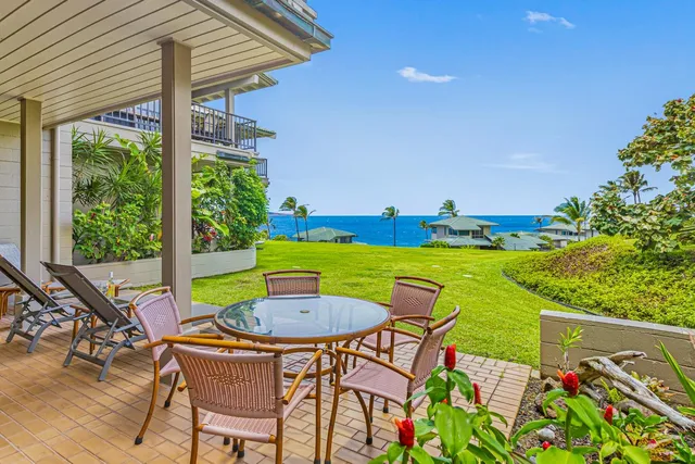 a view of a chairs and table in patio with a swimming pool