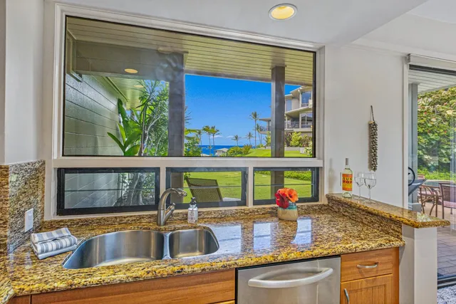 a kitchen with a sink and a large window