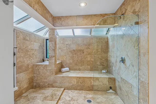 a bathroom with a glass door shower