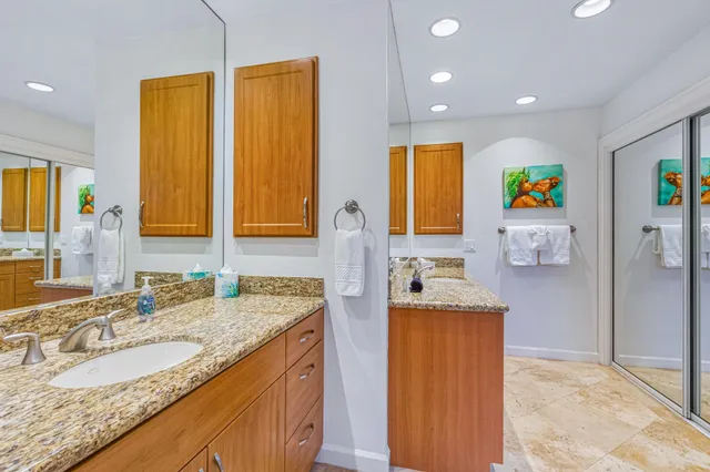 a bedroom with a bed and a painting on the wall