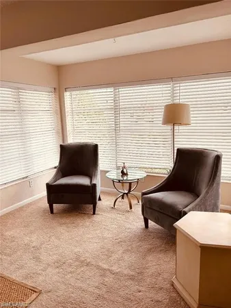 a living room with furniture and a lamp
