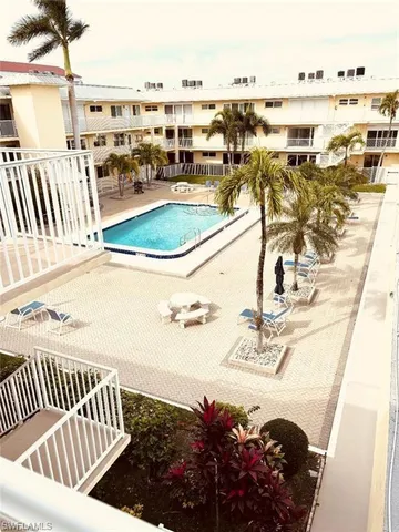 a view of a balcony with chairs and ocean view