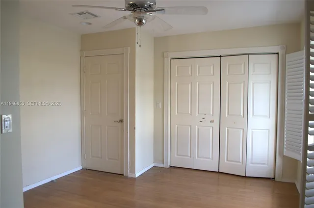 a bathroom with a granite countertop sink toilet and mirror