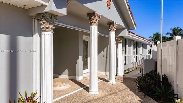 a view of a house with a glass door and porch