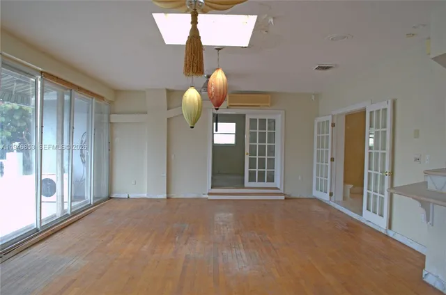 a kitchen with a refrigerator stove and white cabinets