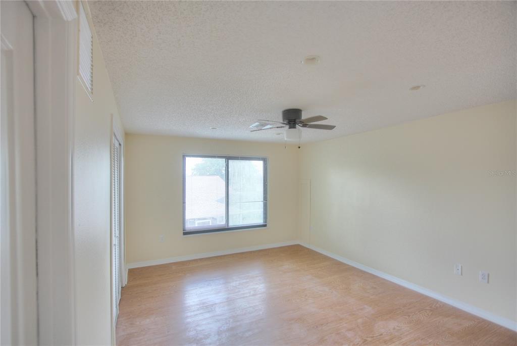 6907 Ranch Road Sarasota, FL 34243 - Photo 11 of 14 an empty room with windows and closet