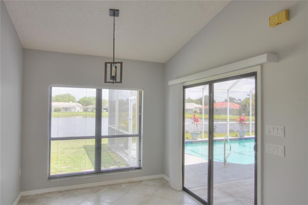 6907 Ranch Road Sarasota, FL 34243 - Photo 8 of 14 a kitchen that has a lot of windows