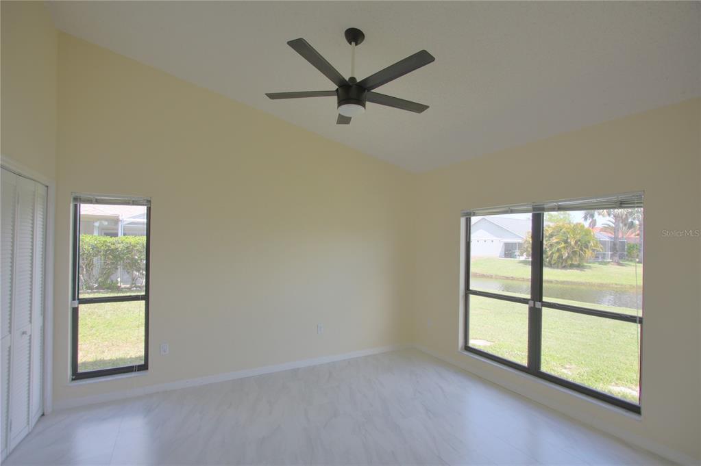 6907 Ranch Road Sarasota, FL 34243 - Photo 9 of 14 an empty room with windows and view of a ceiling fan