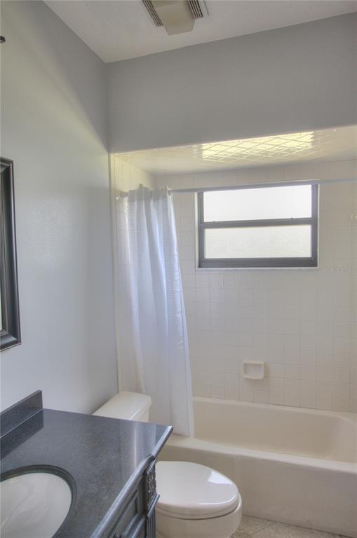 6907 Ranch Road Sarasota, FL 34243 - Photo 10 of 14 a bathroom with a sink a toilet and bathtub