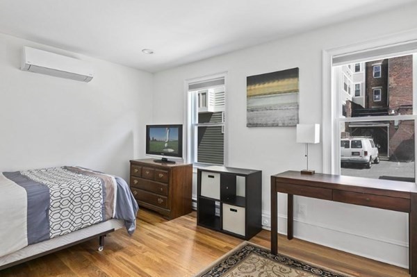 259 Silver Street, Unit 1 Boston, MA 02127 - Photo 4 of 7 a bedroom with furniture and flat screen tv