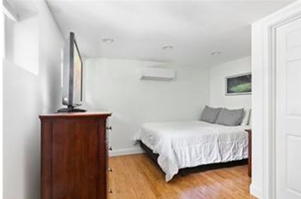 259 Silver Street, Unit 1 Boston, MA 02127 - Photo 6 of 7 a bedroom with a bed and a mirror