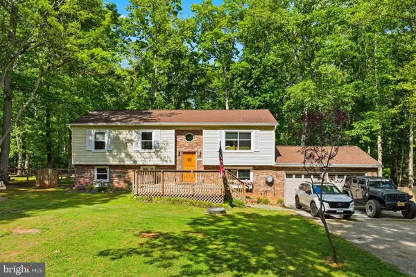 a view of a house with a backyard and a patio
