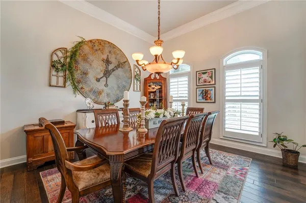 a view of a dining room with furniture wooden floor and chandelier