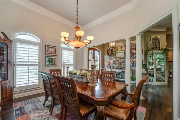 a view of a dining room with furniture wooden floor and chandelier