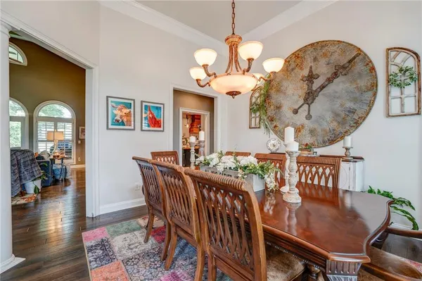 a view of a dining room with furniture wooden floor and a chandelier
