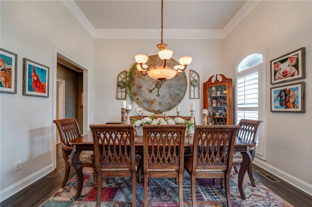 416 Spring Place Road Northeast White, GA 30184 - Photo 16 of 66 a view of a dining room with furniture wooden floor and a chandelier