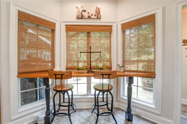 a view of a dining room with furniture large windows and wooden floor