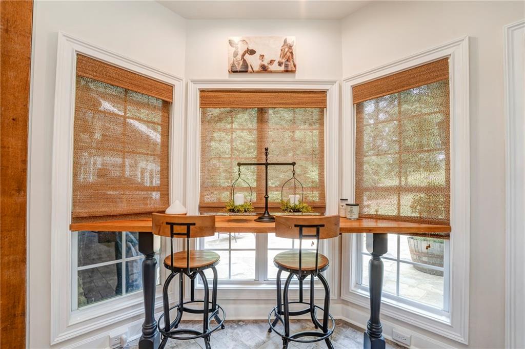 416 Spring Place Road Northeast White, GA 30184 - Photo 18 of 66 a view of a dining room with furniture large windows and wooden floor