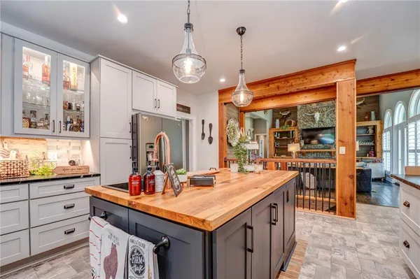 a room with lots of counter space and a chandelier