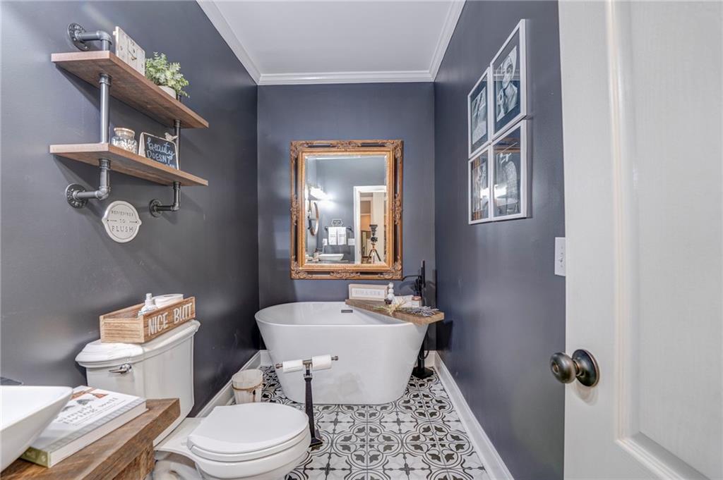 416 Spring Place Road Northeast White, GA 30184 - Photo 30 of 66 a bathroom with a toilet a sink and mirror